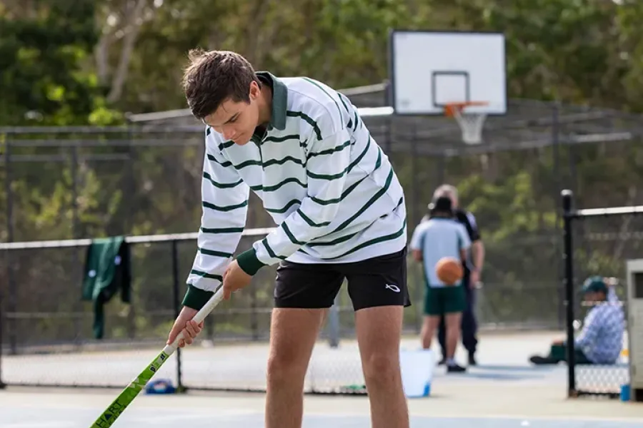 Student practicing hockey at New Hope