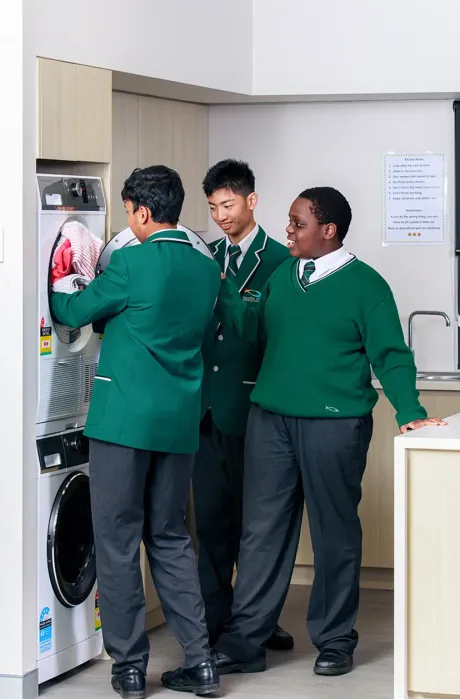 Students loading washing machine at New Hope Christian School